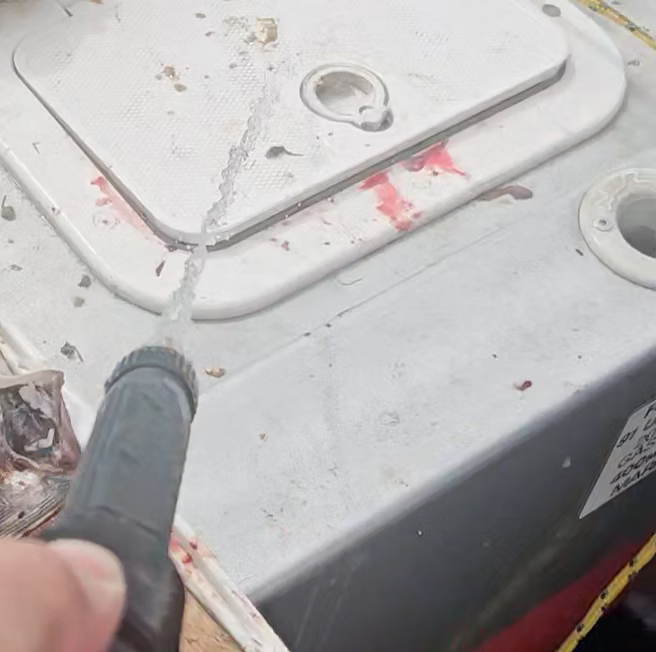 A boat deck covered in bait and scales after a day fishing